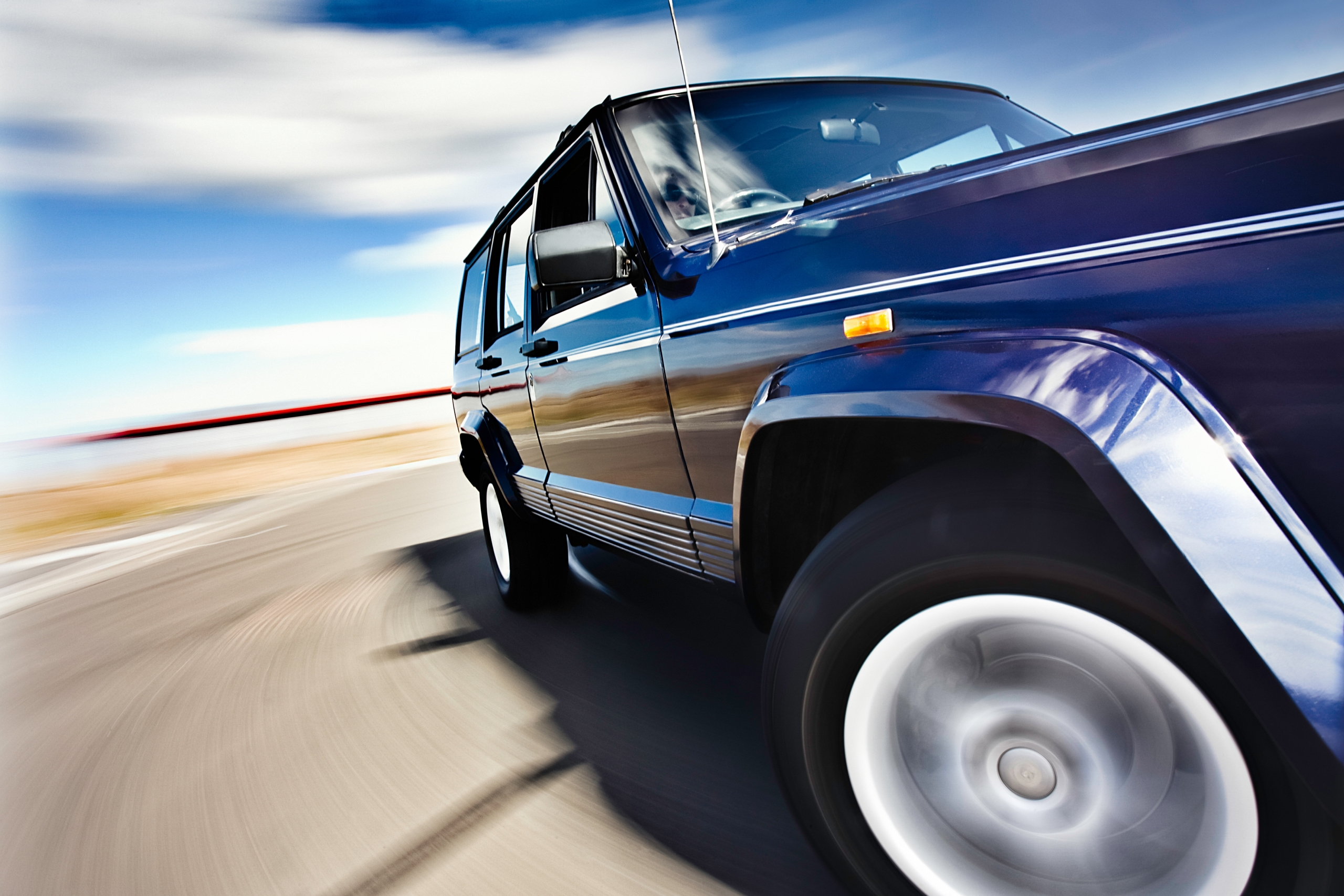 Blue Jeep In Motion 1